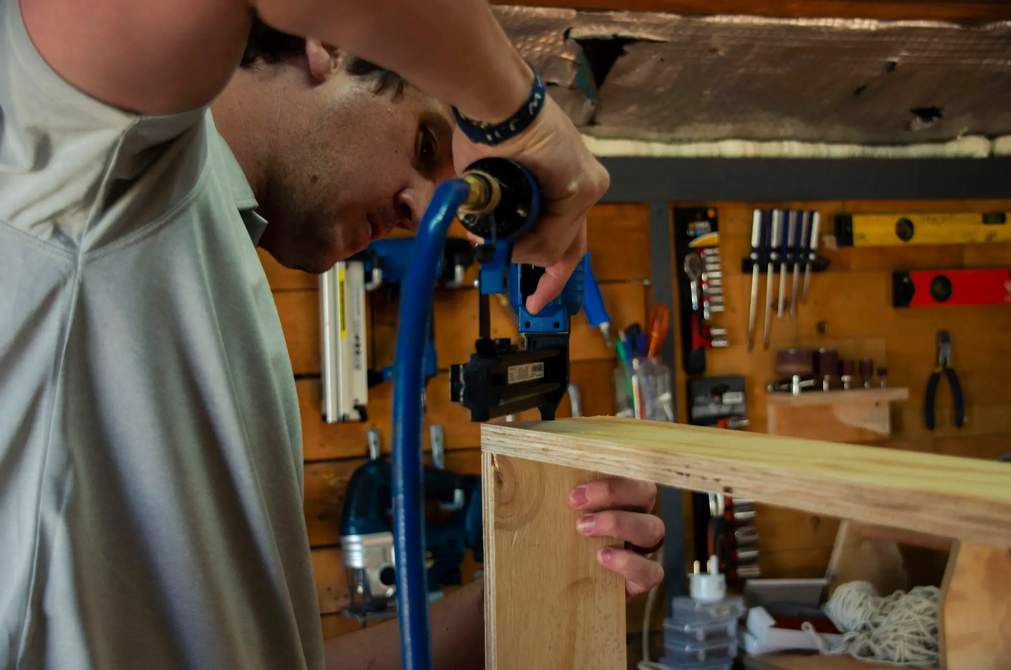 Tradie clamping timber at his workshop bench